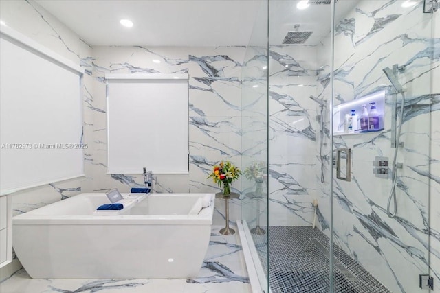 full bath with tile walls, a soaking tub, marble finish floor, and a marble finish shower