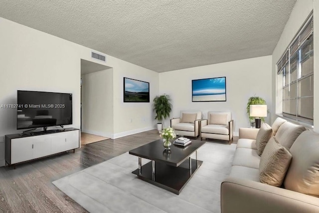 9050 NW 28th St Unit 114, Coral Springs, FL 33065 - living room with wood finished floors and a textured ceiling