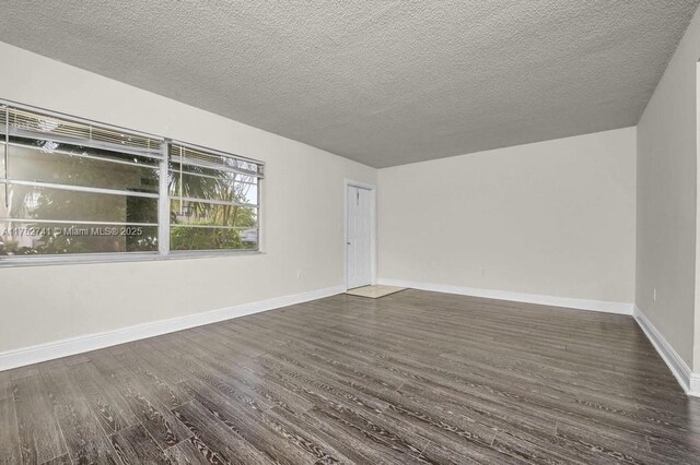 9050 NW 28th St Unit 114, Coral Springs, FL 33065 - empty room with dark wood-style flooring and a textured ceiling
