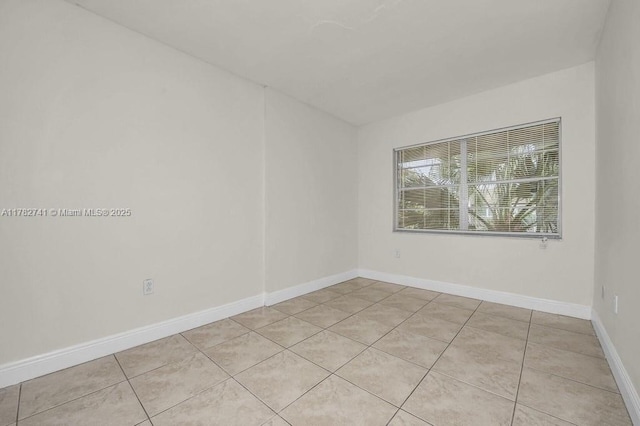 9050 NW 28th St Unit 114, Coral Springs, FL 33065 - empty room featuring light tile patterned floors and baseboards