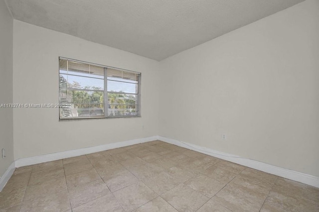 9050 NW 28th St Unit 114, Coral Springs, FL 33065 - unfurnished room with baseboards and light tile patterned floors