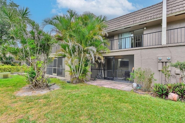 9050 NW 28th St Unit 114, Coral Springs, FL 33065 - rear view of house featuring stucco siding, a tiled roof, a yard, and a balcony