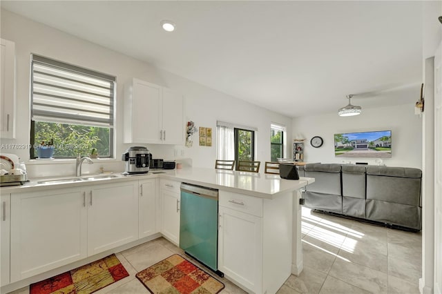 20900 NE 2nd Ct, Miami, FL 33179 - kitchen featuring white cabinets, dishwasher, a sink, light countertops, and a peninsula