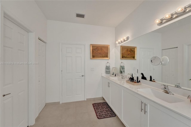 20900 NE 2nd Ct, Miami, FL 33179 - bathroom with double vanity, visible vents, baseboards, and a sink