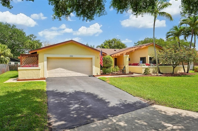 ranch-style house featuring a garage, driveway, stucco siding, and a front lawn
