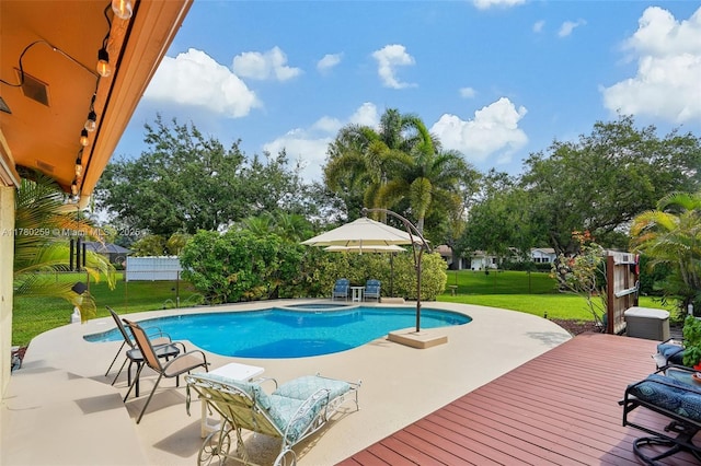 outdoor pool featuring a patio, a yard, and fence