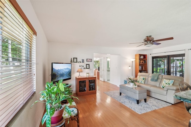 living area featuring a ceiling fan and wood finished floors