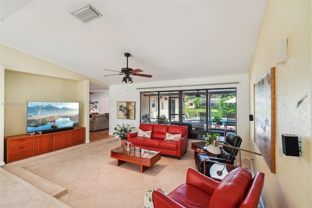 living room featuring visible vents, tile patterned floors, a ceiling fan, and lofted ceiling