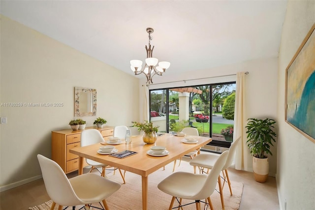 dining area featuring a notable chandelier and lofted ceiling