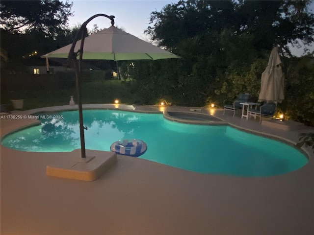 view of swimming pool featuring a patio area, an in ground hot tub, and a fenced in pool
