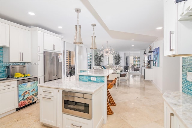 100 S Birch Rd Unit 1602C, Fort Lauderdale, FL 33316 - kitchen featuring stainless steel appliances, decorative backsplash, white cabinets, recessed lighting, and light stone countertops