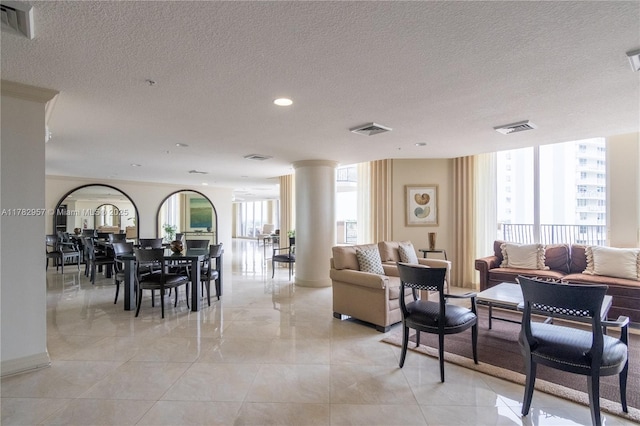 100 S Birch Rd Unit 1602C, Fort Lauderdale, FL 33316 - living room with a textured ceiling, recessed lighting, and decorative columns