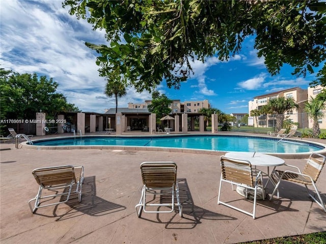 pool featuring a patio area and fence