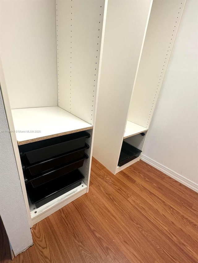 room details featuring baseboards and wood finished floors