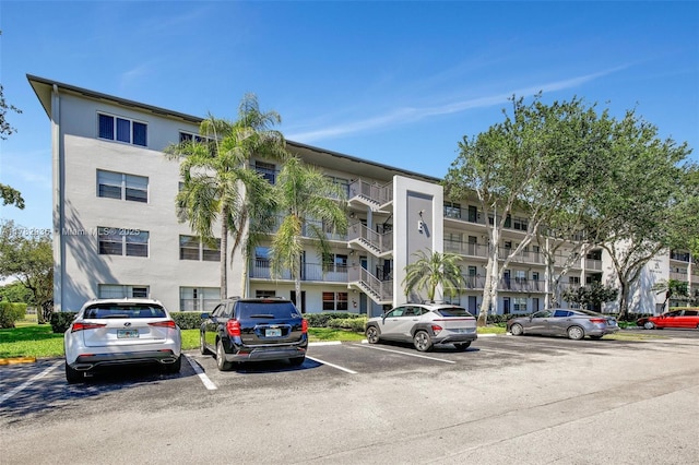 view of building exterior featuring uncovered parking