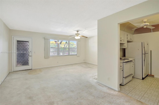 unfurnished living room with light carpet, ceiling fan, and baseboards