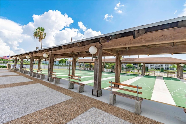 view of property's community featuring shuffleboard