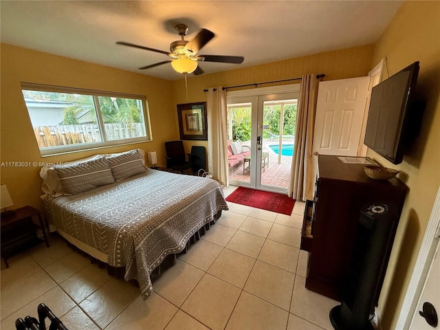 bedroom with french doors, access to outside, light tile patterned flooring, and multiple windows