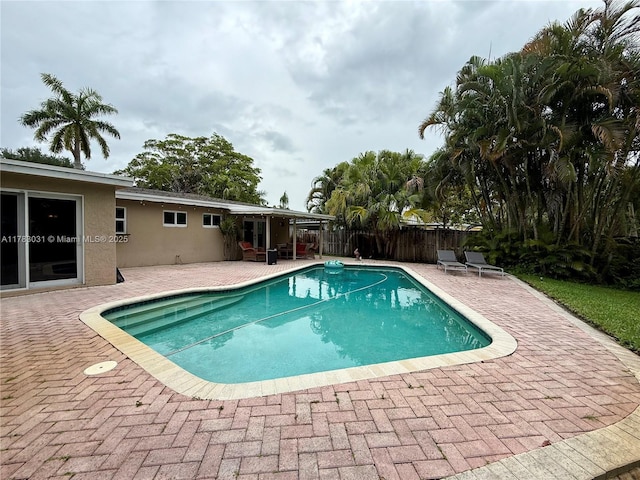 view of pool with a patio, a fenced in pool, and fence