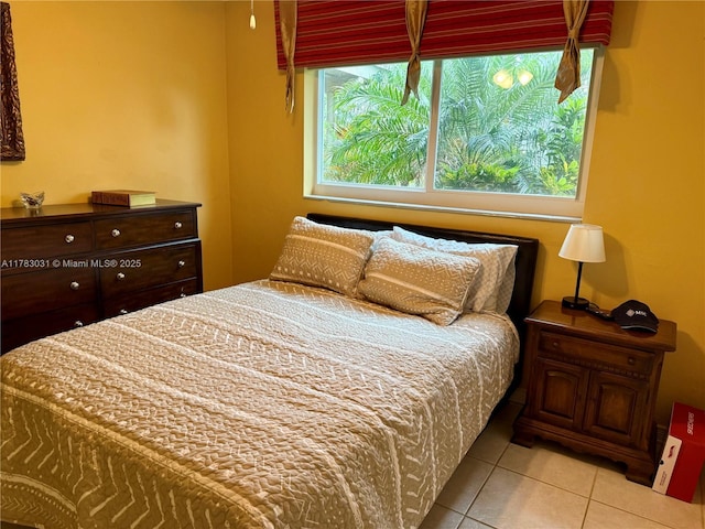 tiled bedroom with multiple windows