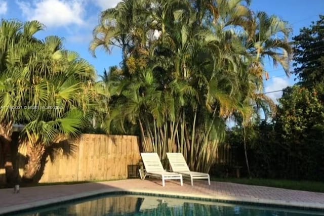 view of swimming pool featuring a fenced in pool and fence