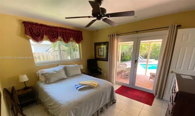 bedroom featuring access to outside, light tile patterned floors, and multiple windows