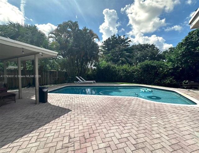 view of pool featuring a patio, a fenced in pool, and fence