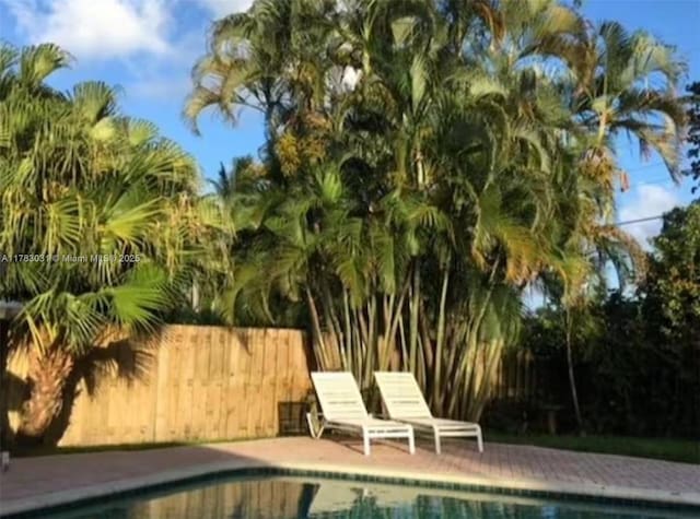 view of swimming pool featuring a fenced in pool and fence