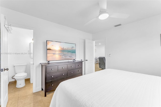 bedroom with a ceiling fan, visible vents, connected bathroom, and light tile patterned flooring