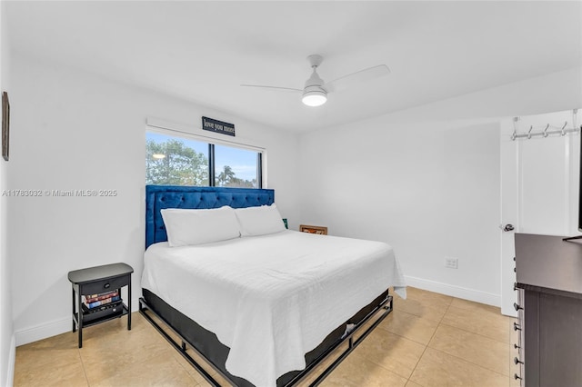 bedroom featuring a ceiling fan, baseboards, and light tile patterned flooring