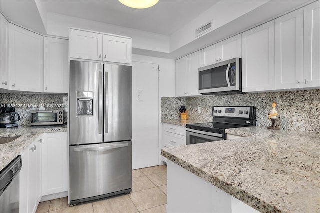 kitchen with white cabinetry, visible vents, appliances with stainless steel finishes, and light tile patterned floors