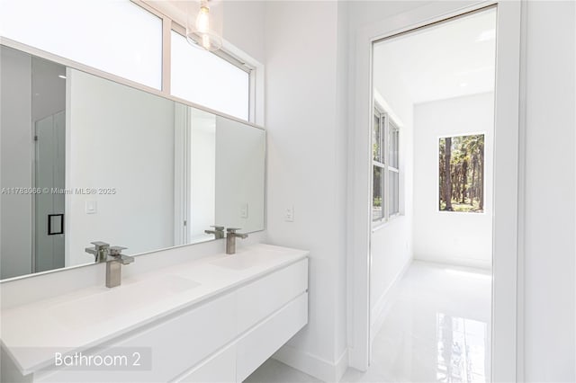 3802 30th Ave SE, Naples, FL 34117 - bathroom featuring double vanity and baseboards