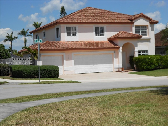 15489 SW 150th St, Miami, FL 33196 - mediterranean / spanish-style home featuring stucco siding, a tiled roof, a front yard, concrete driveway, and an attached garage