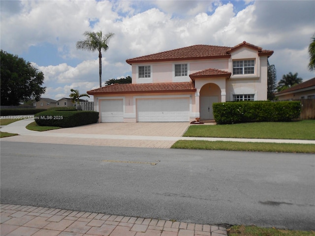 15489 SW 150th St, Miami, FL 33196 - mediterranean / spanish-style home with stucco siding, a tile roof, driveway, a front yard, and an attached garage