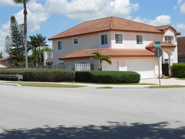 15489 SW 150th St, Miami, FL 33196 - mediterranean / spanish house featuring a garage, a tiled roof, concrete driveway, stucco siding, and fence