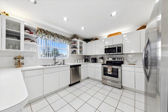 15489 SW 150th St, Miami, FL 33196 - kitchen with decorative backsplash, open shelves, appliances with stainless steel finishes, white cabinets, and a sink
