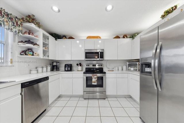 15489 SW 150th St, Miami, FL 33196 - kitchen featuring white cabinets, appliances with stainless steel finishes, light countertops, and decorative backsplash
