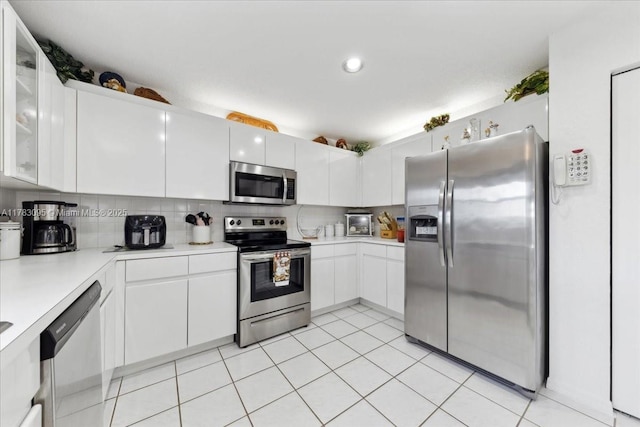 15489 SW 150th St, Miami, FL 33196 - kitchen featuring white cabinetry, decorative backsplash, glass insert cabinets, appliances with stainless steel finishes, and light countertops