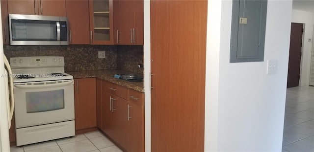 8850 SW 123rd Ct Unit H302, Miami, FL 33186 - kitchen with stainless steel microwave, electric panel, light tile patterned floors, glass insert cabinets, and electric stove