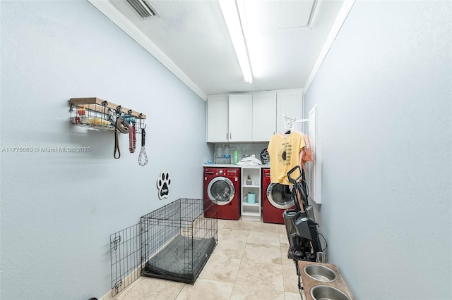 laundry room with cabinet space, light tile patterned flooring, independent washer and dryer, and visible vents