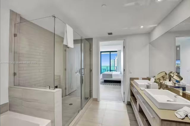 ensuite bathroom with a shower stall, double vanity, ensuite bathroom, and a sink