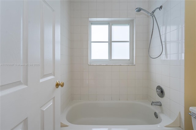 bathroom featuring shower / bath combination and toilet