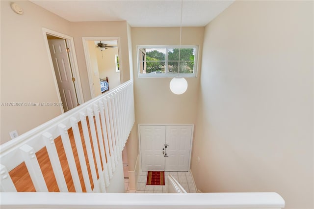 stairs featuring tile patterned flooring and baseboards