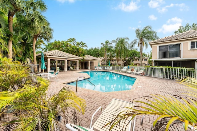 pool featuring a patio area, a gazebo, and fence