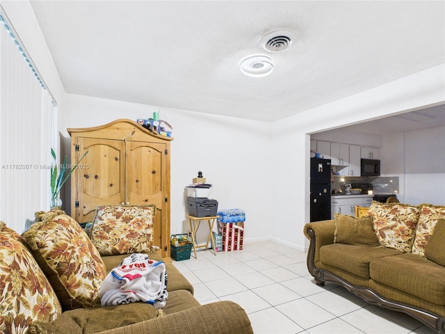 living room with baseboards, visible vents, and light tile patterned floors