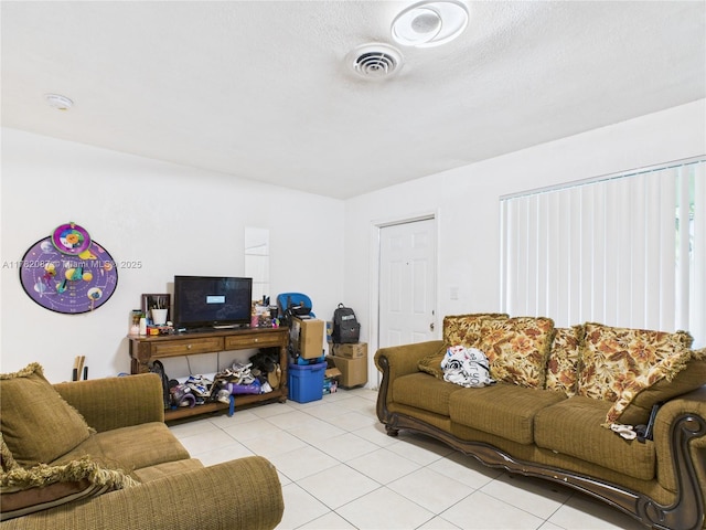 living room featuring visible vents and light tile patterned floors