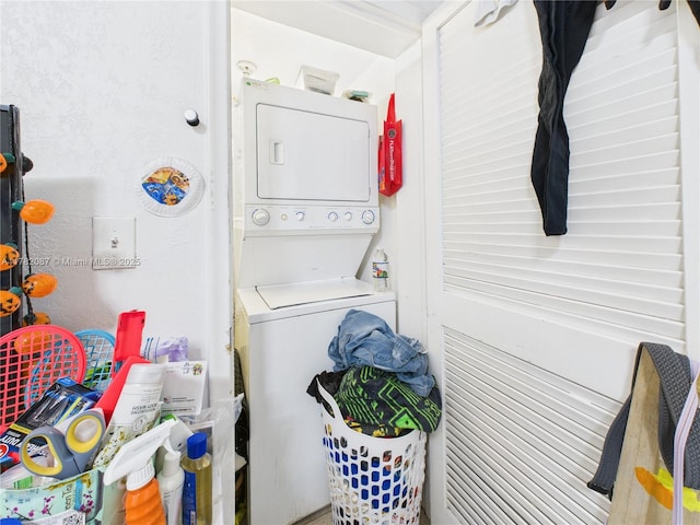 washroom with stacked washer and dryer