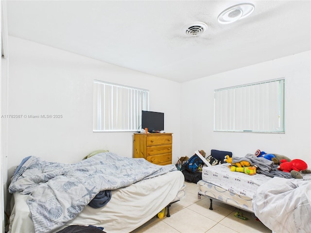 bedroom with tile patterned flooring and visible vents