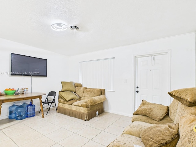 living room featuring visible vents, baseboards, and light tile patterned floors