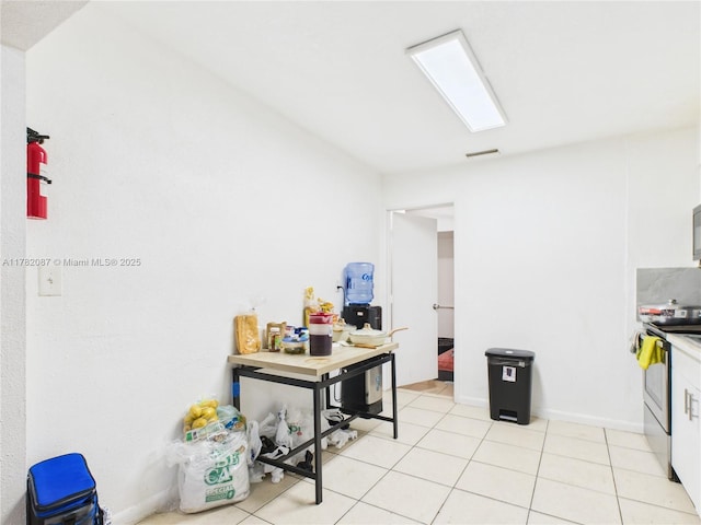 kitchen with stainless steel appliances, visible vents, white cabinetry, and light tile patterned floors